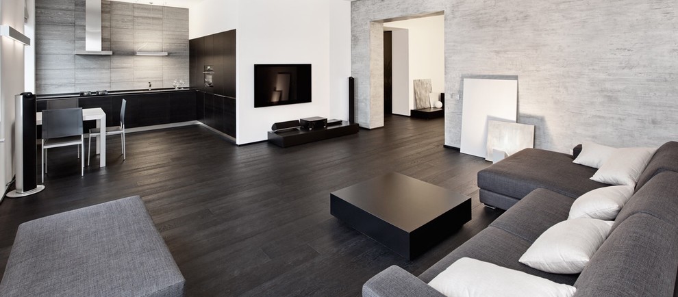 Ispirazione per un grande soggiorno minimalista aperto con pareti grigie, parquet scuro, nessun camino e pavimento nero