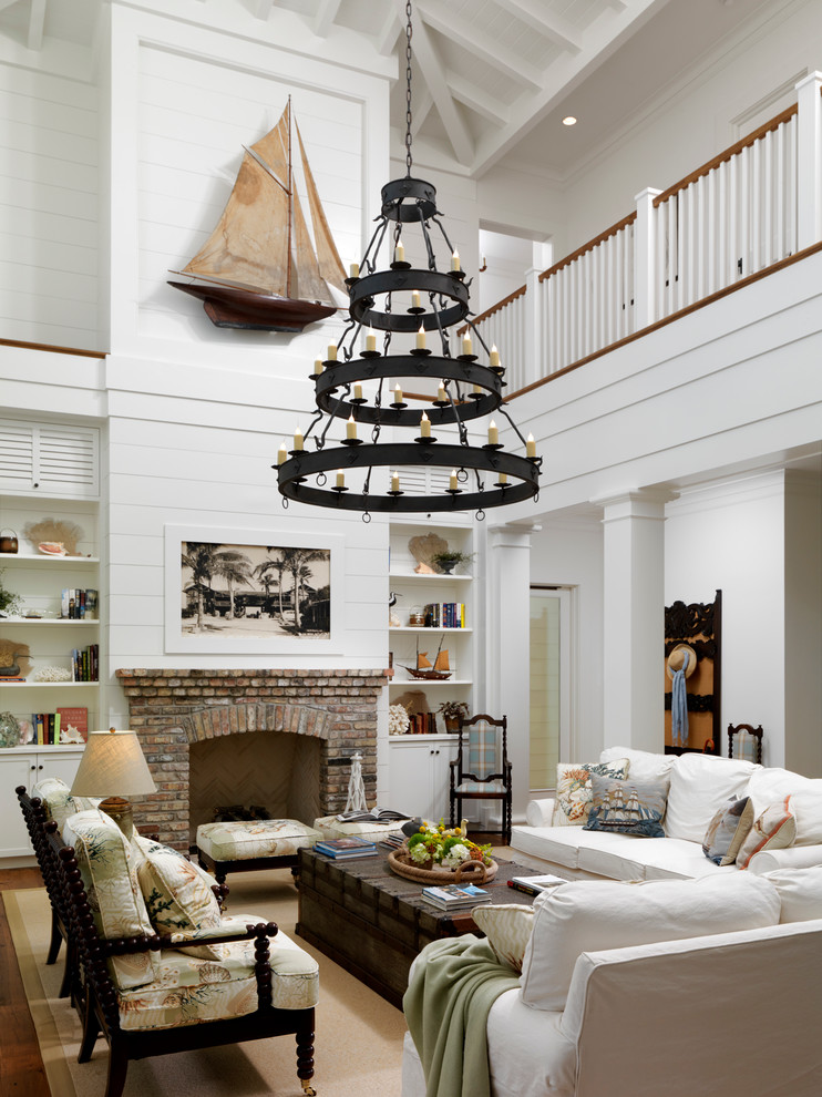 Example of a classic living room design in Orlando with white walls, a standard fireplace and a brick fireplace