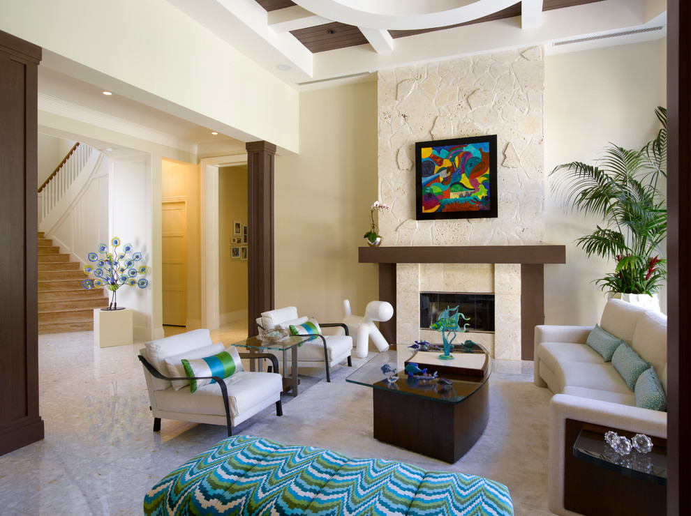 This is an example of a contemporary formal open plan living room in Miami with beige walls, a standard fireplace and a stone fireplace surround.