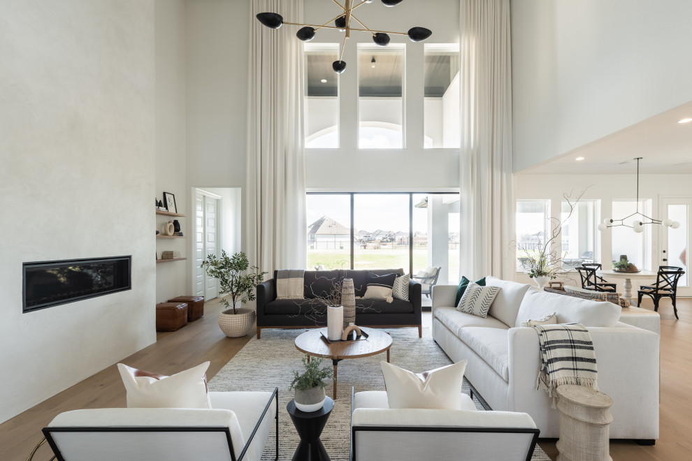 Living room - large transitional open concept light wood floor and beige floor living room idea with white walls, a plaster fireplace and a ribbon fireplace