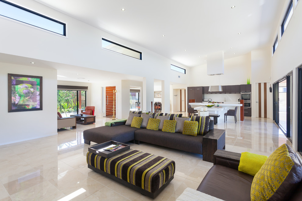 Photo of a large contemporary open plan living room in Brisbane with white walls, marble flooring and a wall mounted tv.