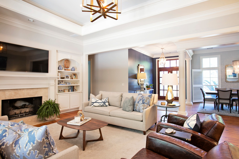 Photo of a medium sized traditional formal open plan living room in Atlanta with white walls, medium hardwood flooring, a tiled fireplace surround, a standard fireplace, a wall mounted tv and brown floors.