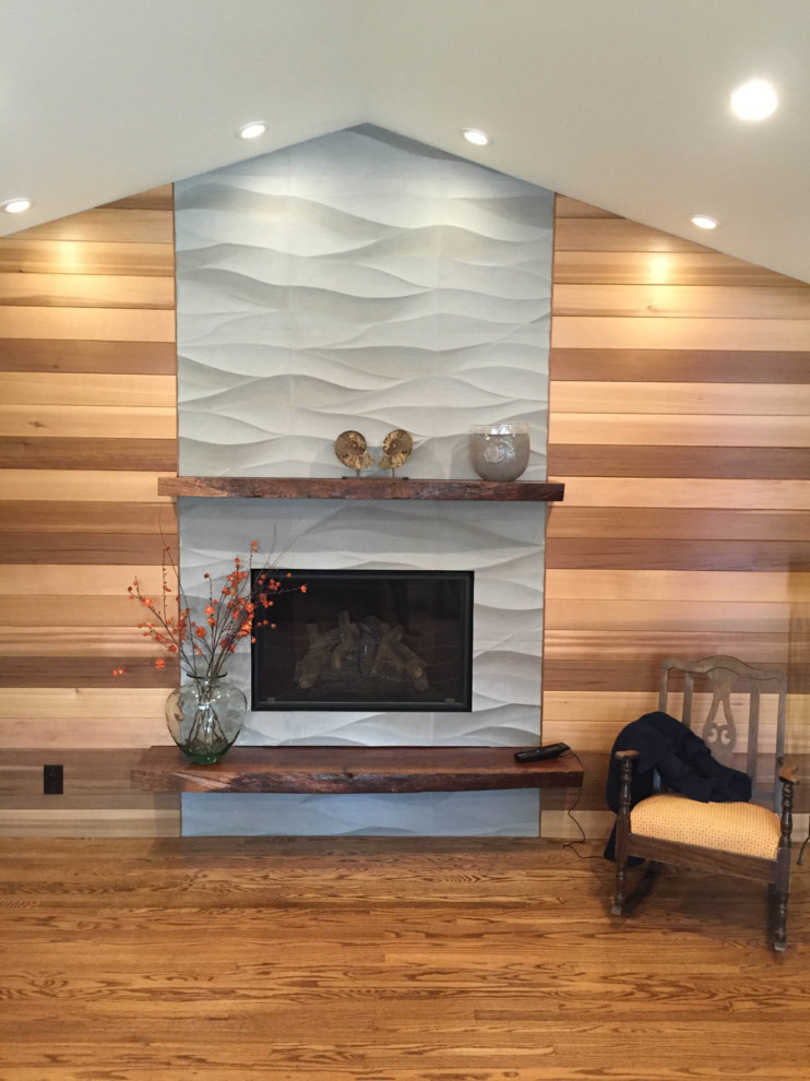 Inspiration for a transitional medium tone wood floor, vaulted ceiling and wood wall living room remodel in San Francisco with a standard fireplace and a stone fireplace
