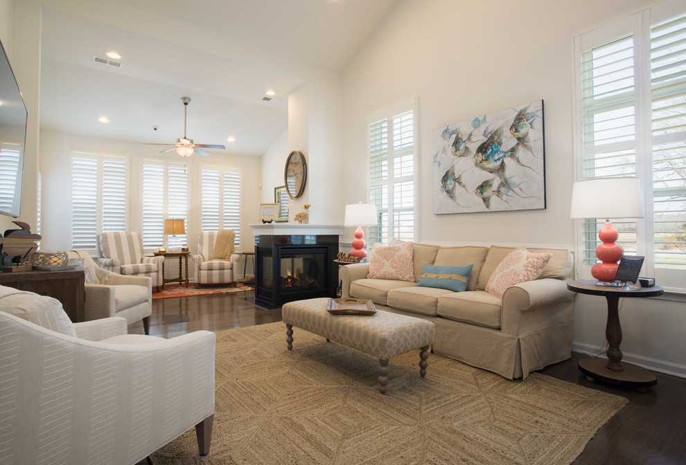 This is an example of a medium sized coastal formal open plan living room in Other with white walls, medium hardwood flooring, a wall mounted tv, brown floors, a two-sided fireplace and a plastered fireplace surround.