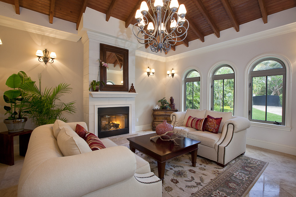 Photo of a large bohemian living room in Miami with a standard fireplace.