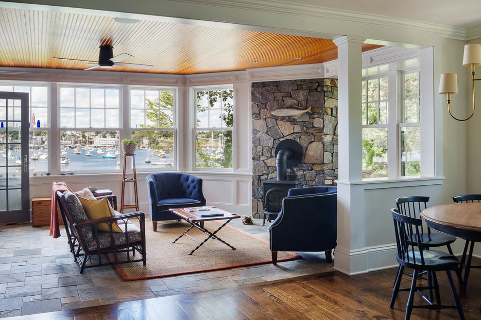 Inspiration for a mid-sized craftsman formal and open concept slate floor living room remodel in Boston with white walls, a wood stove, a stone fireplace and no tv