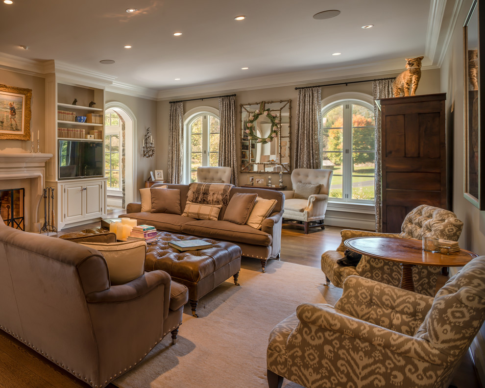 Large traditional formal enclosed living room in Philadelphia with beige walls, medium hardwood flooring, a stone fireplace surround and a built-in media unit.