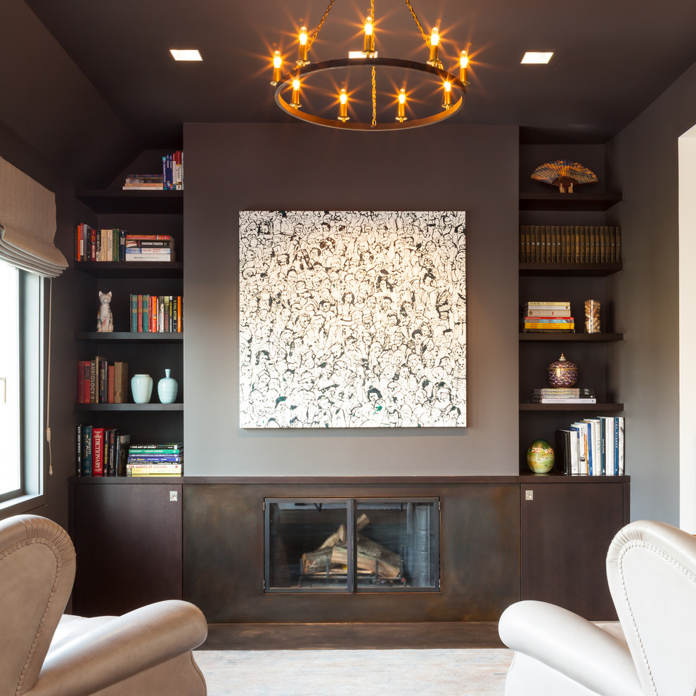На фото: изолированная гостиная комната среднего размера в стиле модернизм с с книжными шкафами и полками, стандартным камином, серыми стенами, темным паркетным полом, фасадом камина из бетона и коричневым полом без телевизора