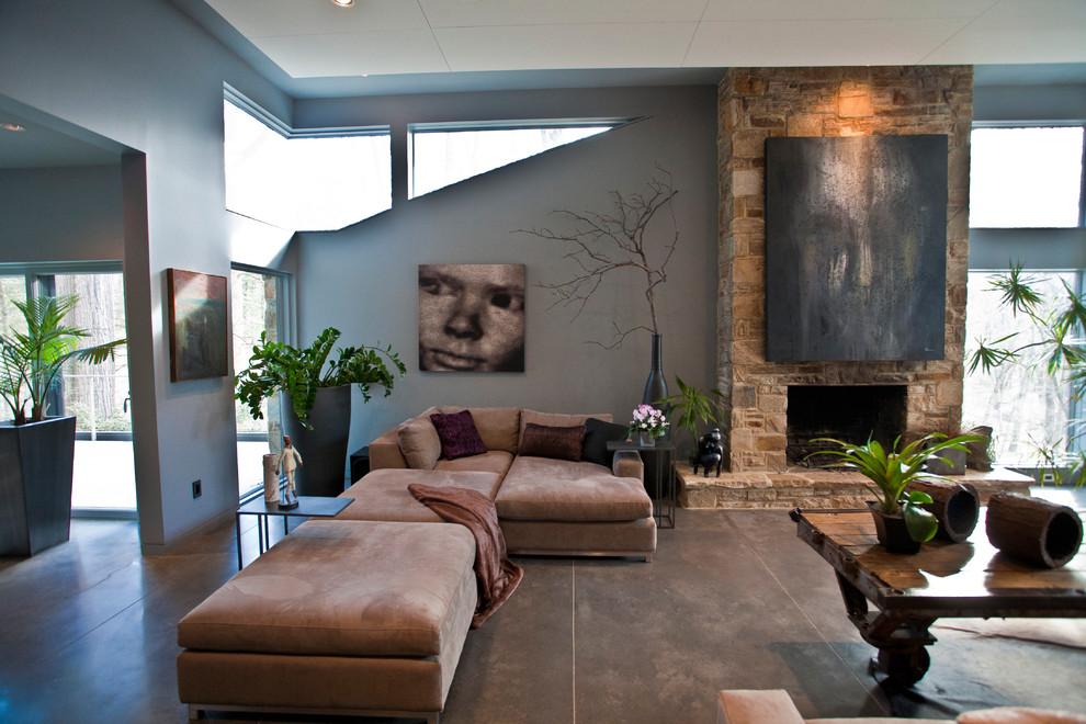 ボルチモアにあるラグジュアリーな巨大なコンテンポラリースタイルのおしゃれなLDK (グレーの壁、コンクリートの床、標準型暖炉、石材の暖炉まわり、テレビなし、グレーの床) の写真