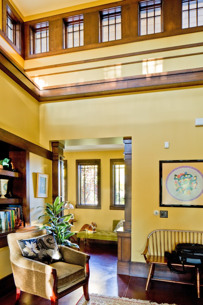 Living room library - huge craftsman open concept concrete floor living room library idea in Denver with yellow walls, no fireplace and no tv