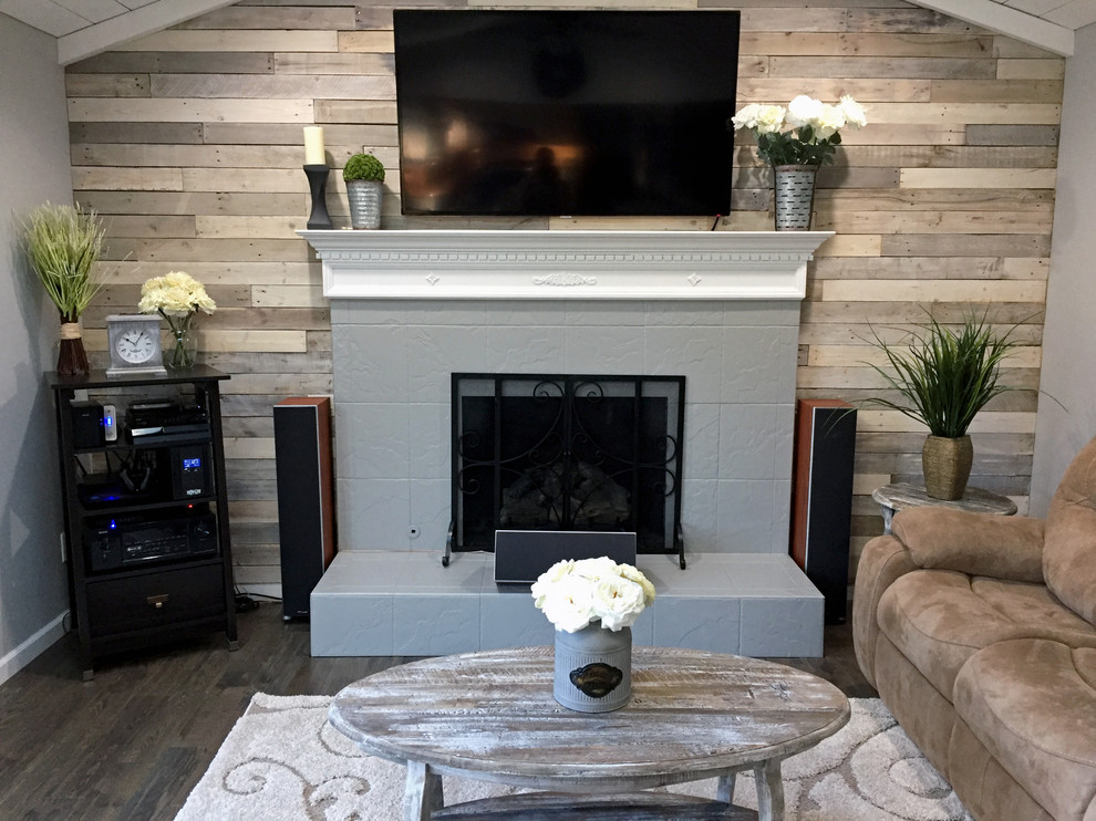 Example of a cottage open concept dark wood floor living room design in Philadelphia with gray walls, a standard fireplace, a tile fireplace and a wall-mounted tv