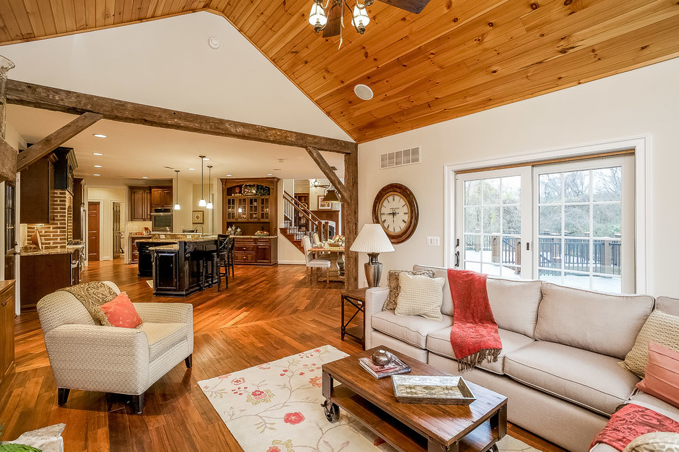 Example of a mid-sized cottage open concept brown floor and medium tone wood floor living room design in Baltimore with white walls