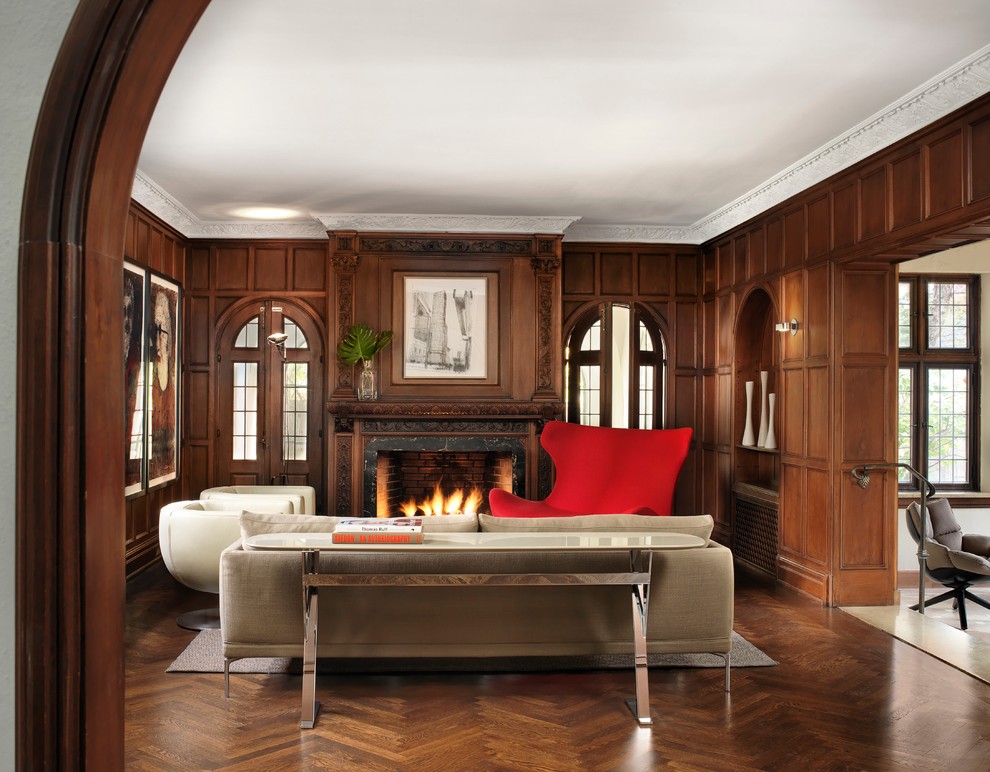 Example of a mid-sized eclectic formal and enclosed medium tone wood floor living room design in St Louis with brown walls, a standard fireplace, a metal fireplace and no tv