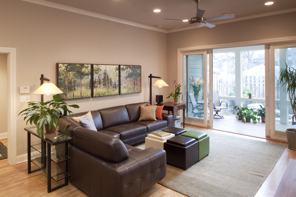 Mid-sized elegant open concept light wood floor living room photo in Austin with beige walls