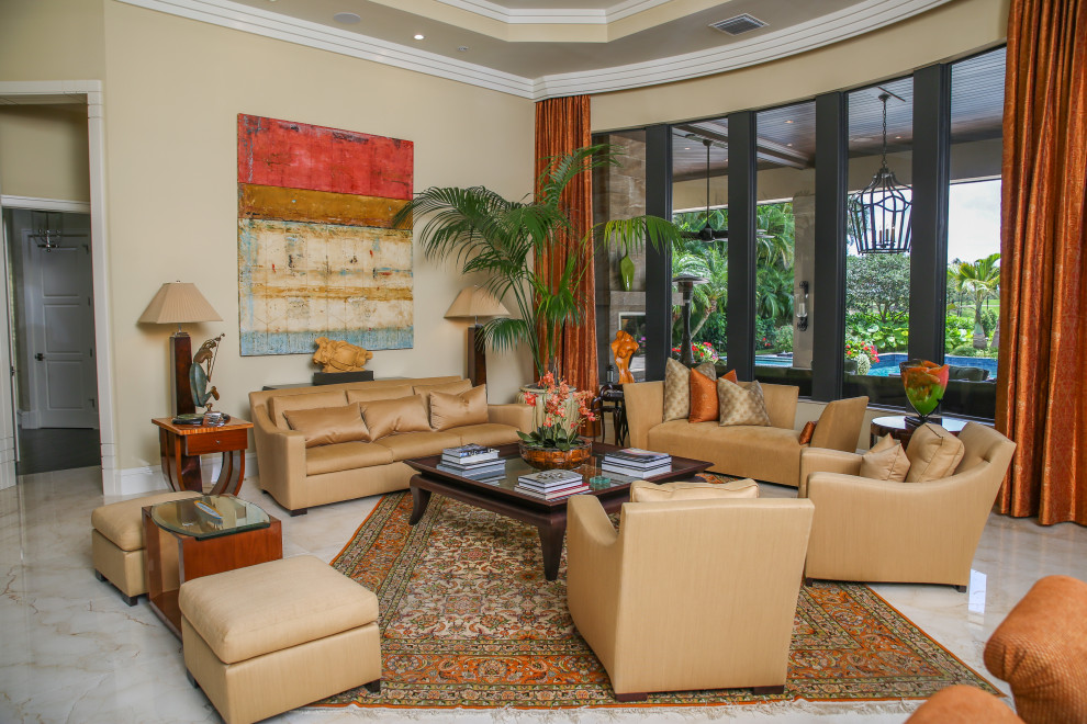 Photo of a world-inspired open plan living room in Miami with beige walls and beige floors.