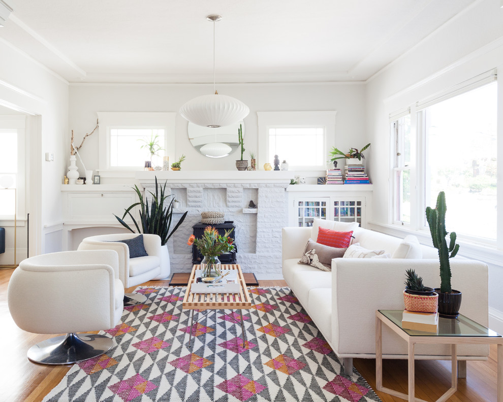 Living room - mid-sized transitional open concept medium tone wood floor and white floor living room idea in San Francisco with white walls, a standard fireplace and a brick fireplace