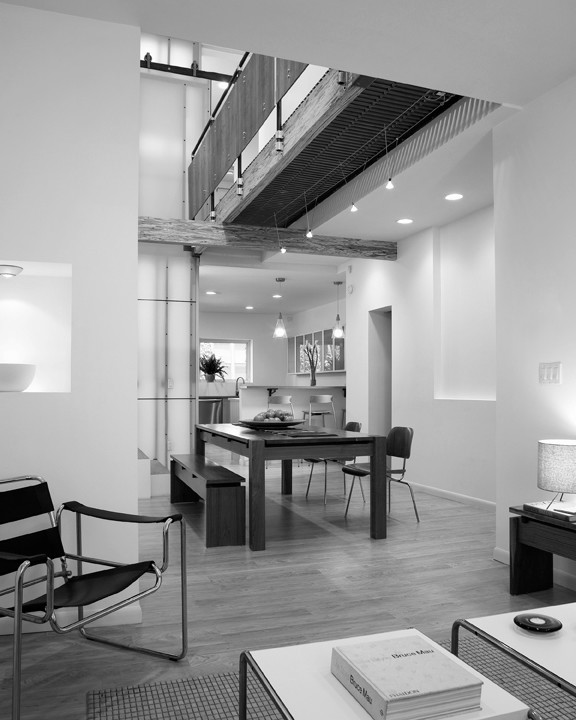 Свежая идея для дизайна: двухуровневая гостиная комната среднего размера в современном стиле с белыми стенами и коричневым полом - отличное фото интерьера