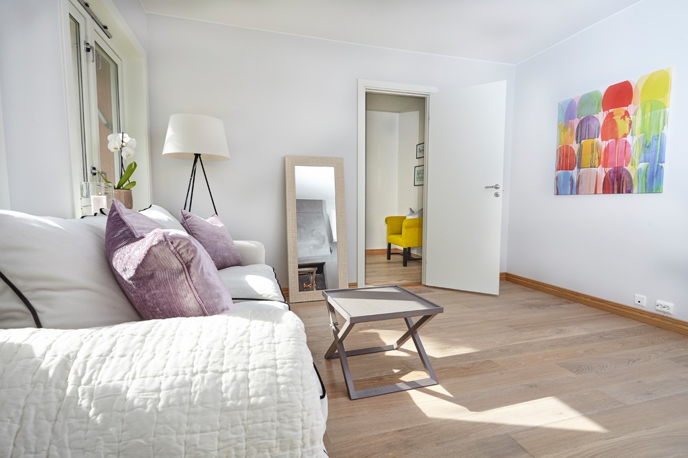 Modelo de salón para visitas abierto tradicional renovado pequeño sin televisor con paredes blancas, suelo de madera clara, estufa de leña y suelo marrón