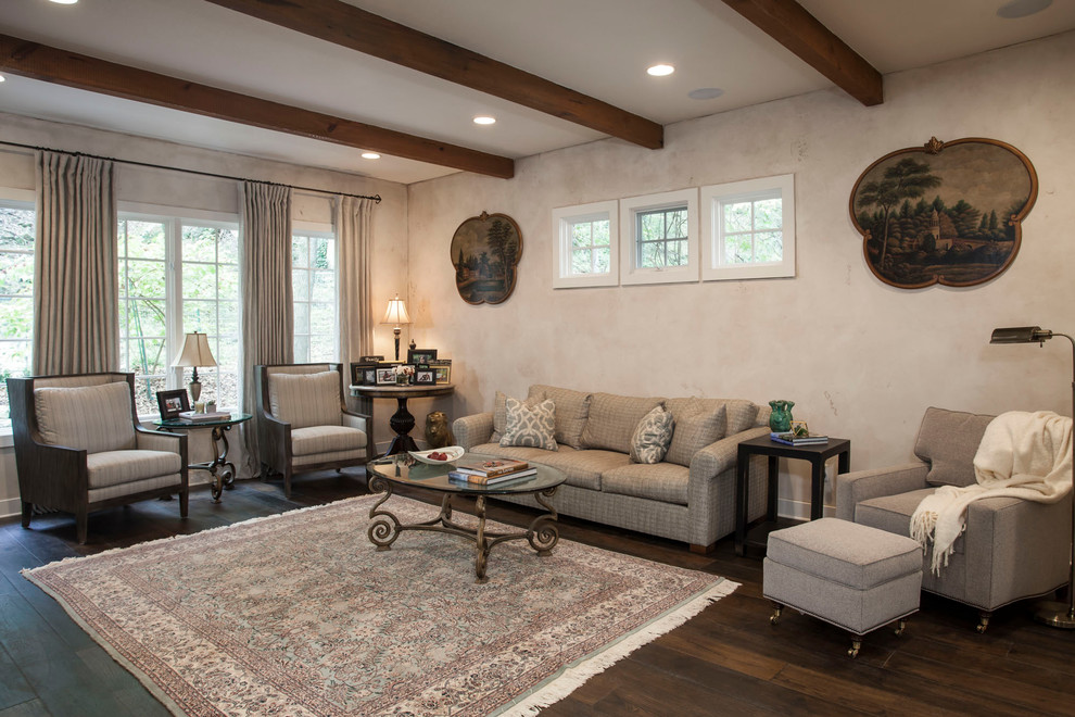 Klassisches Wohnzimmer mit beiger Wandfarbe, dunklem Holzboden und Kaminumrandung aus Stein in Austin