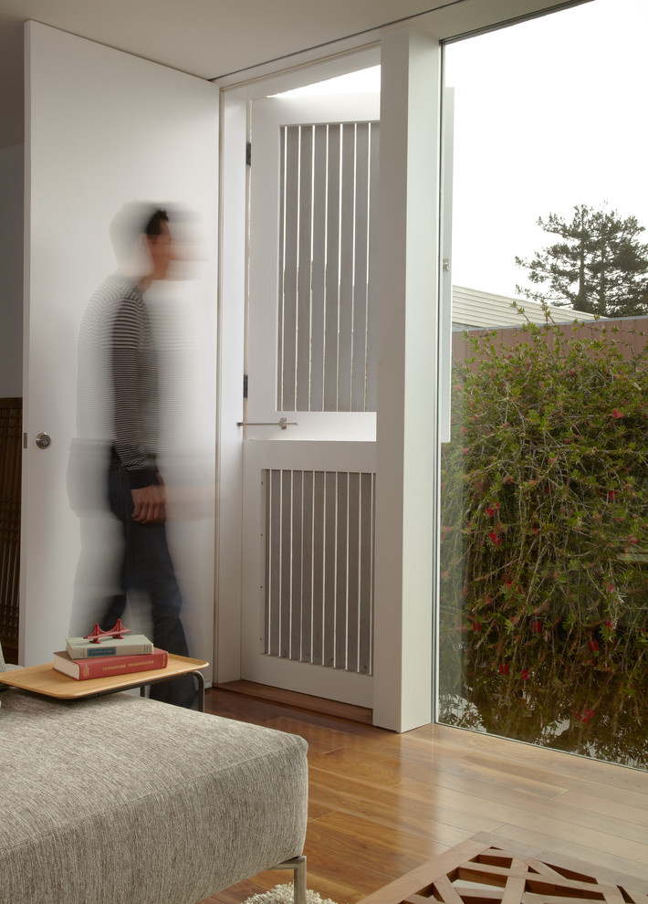 Idee per un soggiorno moderno con pareti bianche e pavimento in legno massello medio