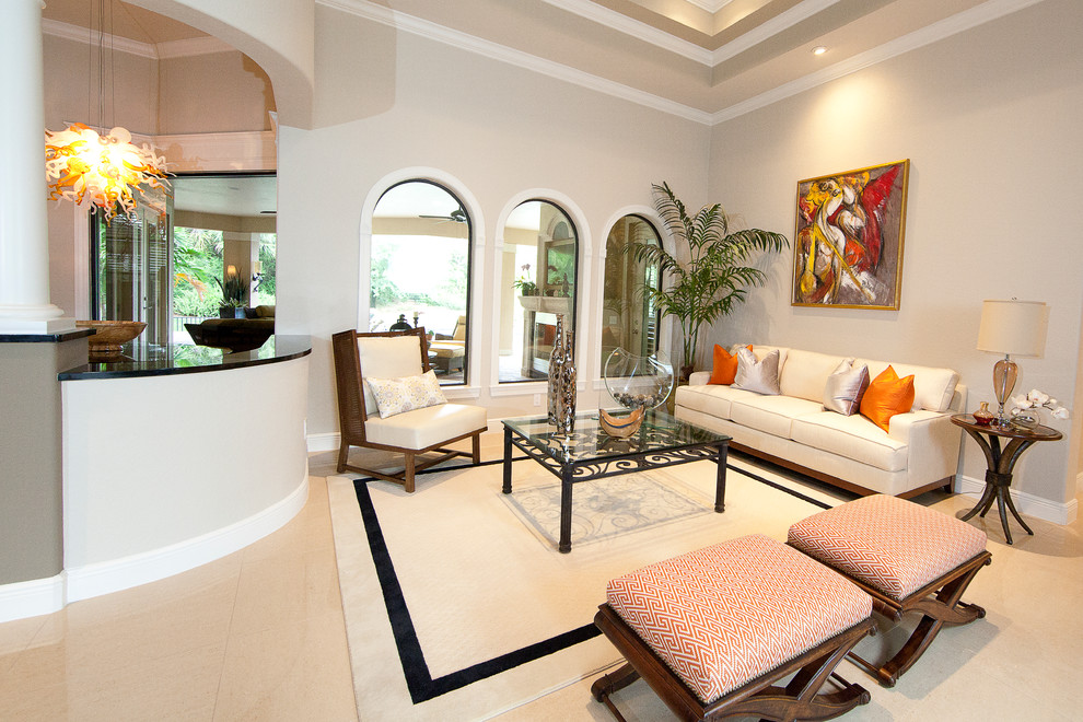 Inspiration for a mediterranean open plan living room in Miami with beige walls and porcelain flooring.