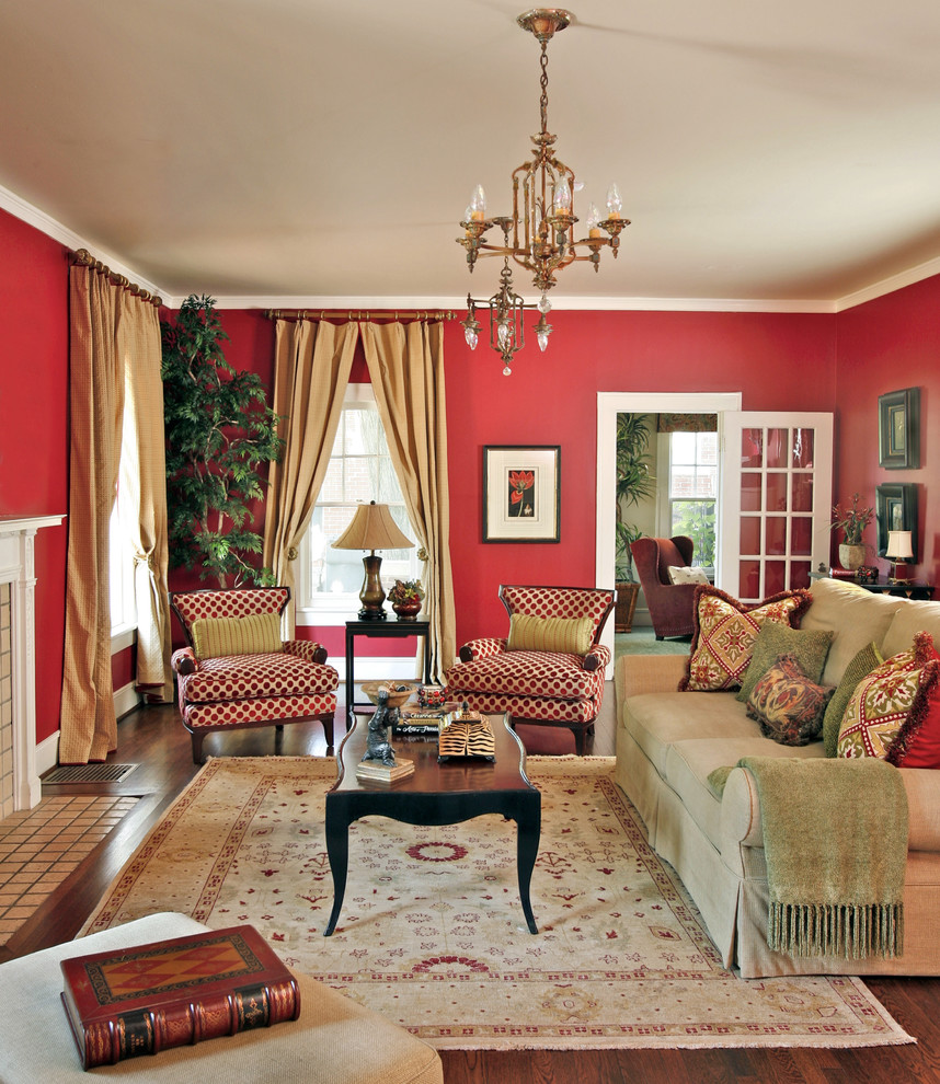 Inspiration for a large timeless enclosed medium tone wood floor living room remodel in Dallas with red walls, a standard fireplace, a stone fireplace and a wall-mounted tv