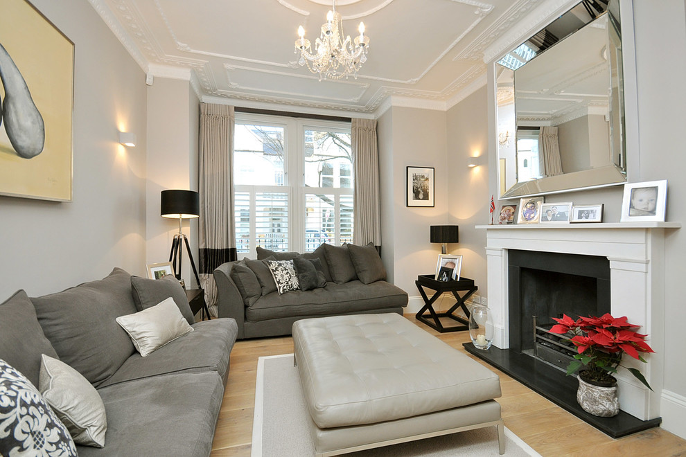 Example of a trendy living room design in London with gray walls