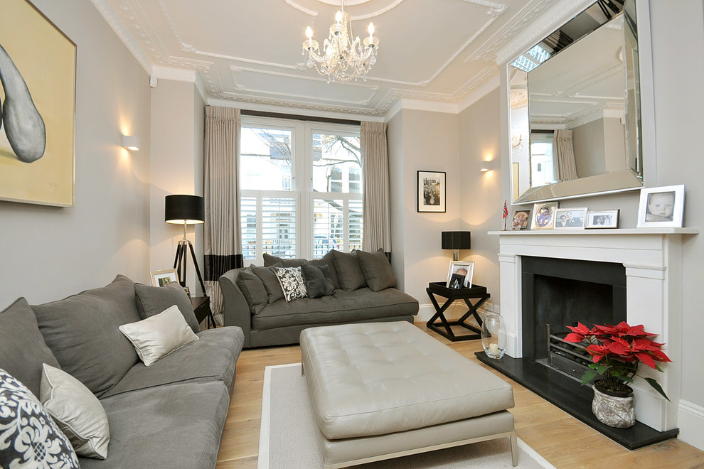 Contemporary living room in London with grey walls and feature lighting.