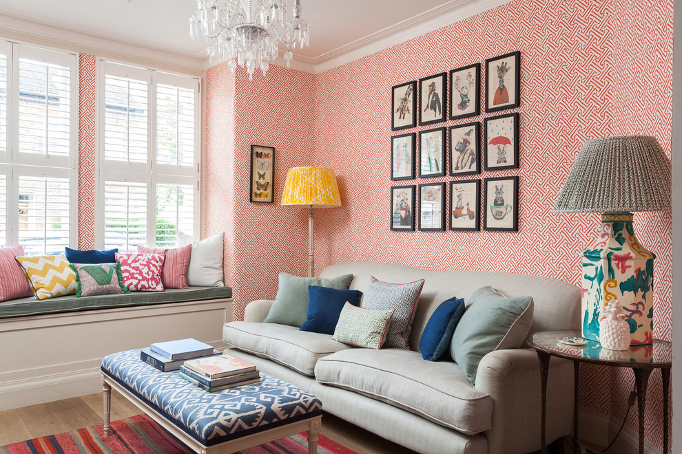 This is an example of a traditional formal and grey and pink enclosed living room in London with orange walls, light hardwood flooring and beige floors.