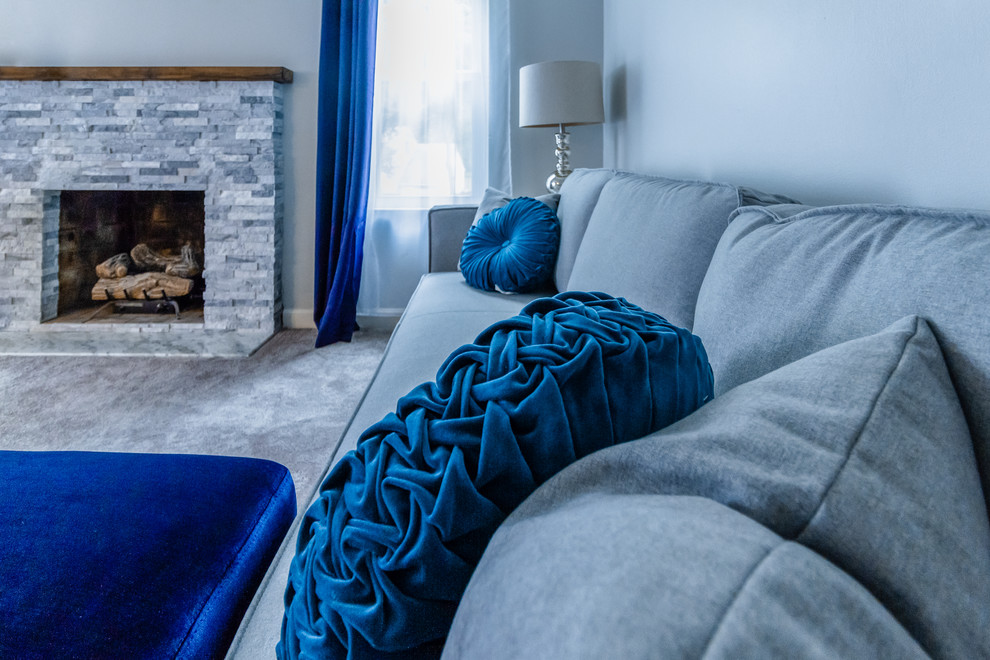 Photo of a medium sized contemporary formal enclosed living room in Philadelphia with grey walls, carpet, a standard fireplace, a stone fireplace surround, no tv and grey floors.