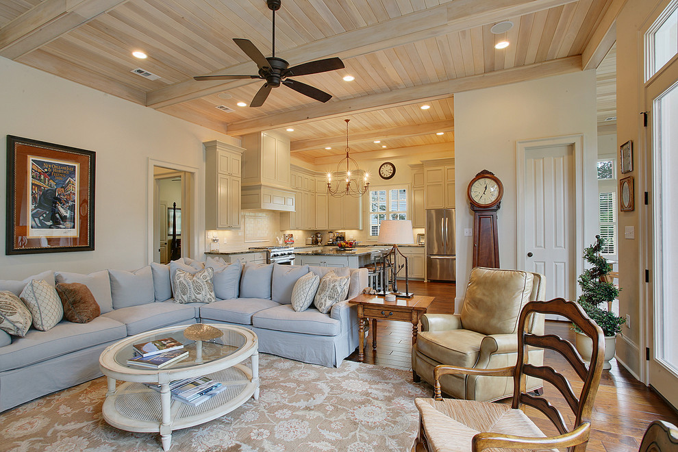 Romantic living room in New Orleans with beige walls and dark hardwood flooring.