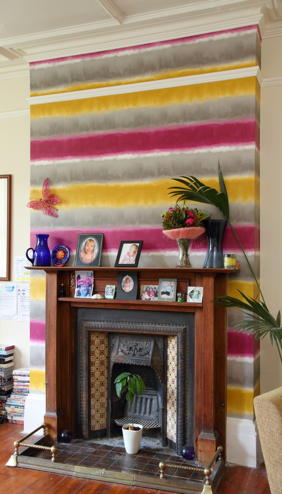 Living room - large eclectic enclosed medium tone wood floor living room idea in London with multicolored walls, a standard fireplace, a tile fireplace and no tv