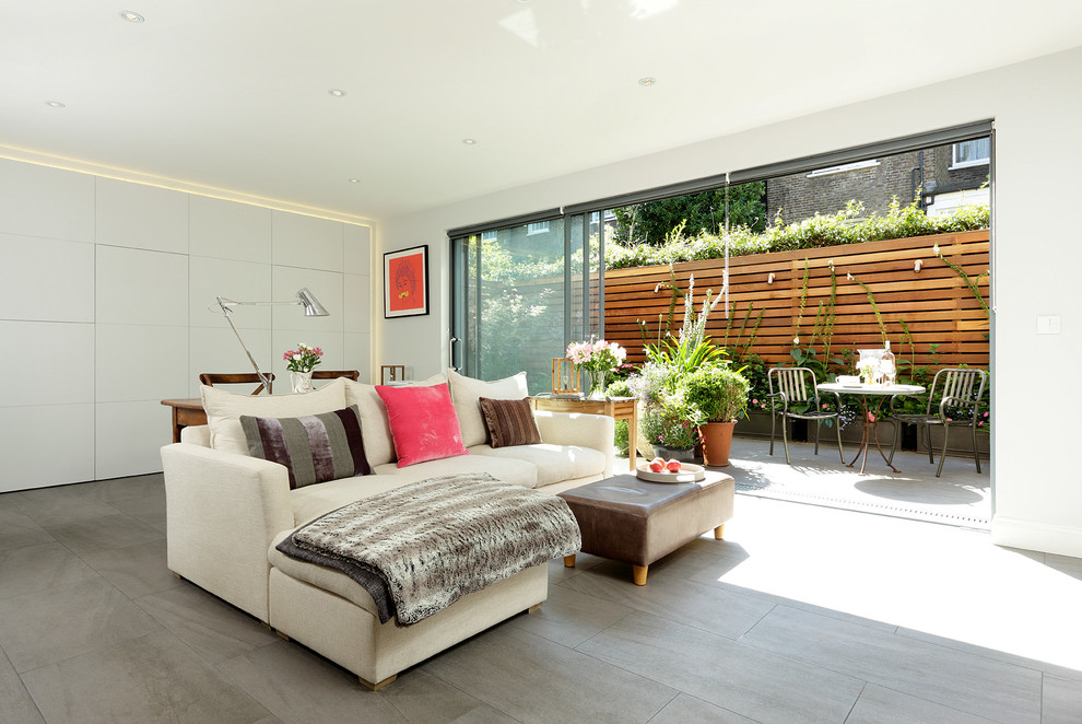 Design ideas for a contemporary open plan living room in London with white walls and porcelain flooring.