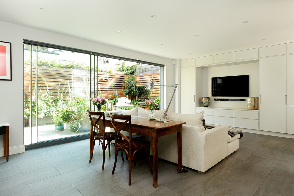 Living room - contemporary porcelain tile living room idea in London