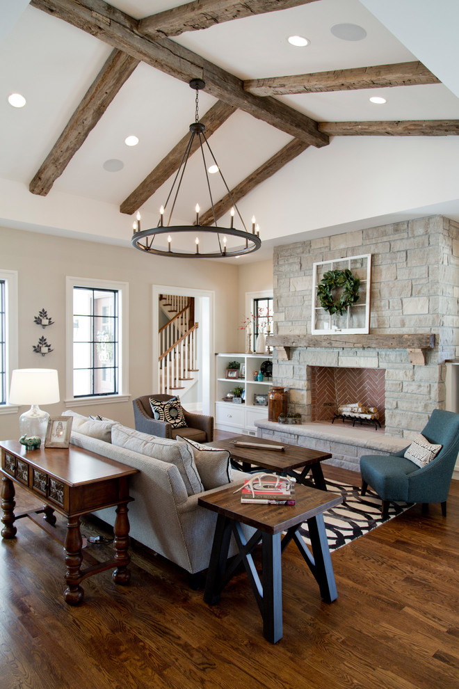 Inspiration for a classic formal open plan living room in St Louis with beige walls, dark hardwood flooring, a standard fireplace, a stone fireplace surround, no tv and brown floors.