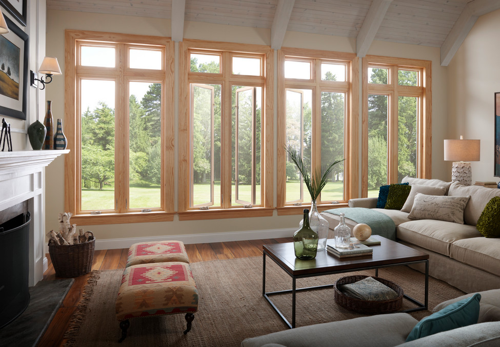 This is an example of a medium sized classic enclosed living room in Toronto with beige walls, medium hardwood flooring, a standard fireplace and a wooden fireplace surround.