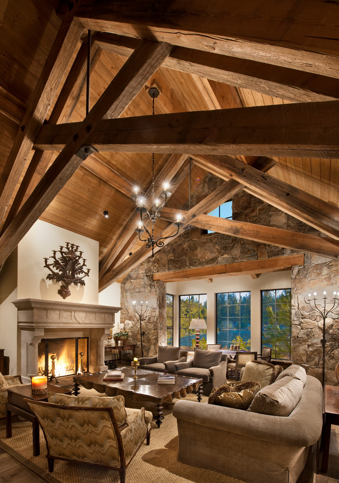 This is an example of a large rustic formal enclosed living room in Sacramento with multi-coloured walls, medium hardwood flooring, a standard fireplace, a plastered fireplace surround, no tv and beige floors.