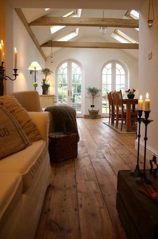 Modelo de salón abierto clásico renovado grande con paredes blancas y suelo de madera en tonos medios