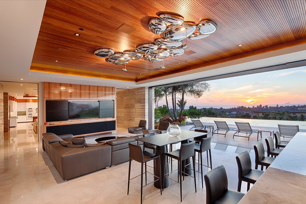 Photo of an expansive contemporary open concept living room in San Diego with a home bar, white walls, travertine floors and a built-in media wall.