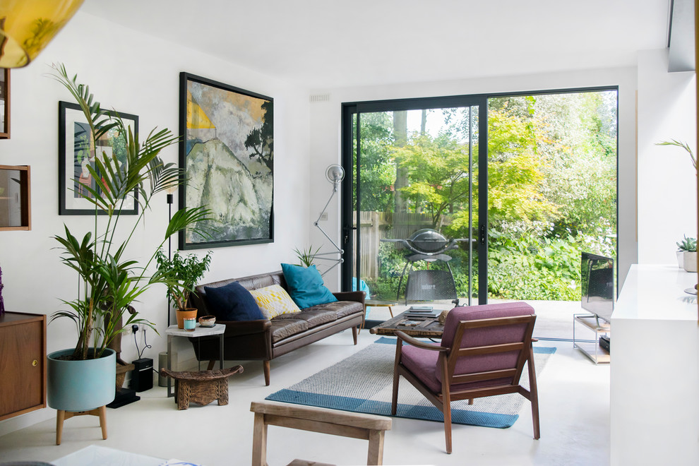 This is an example of a midcentury living room in London with white walls.