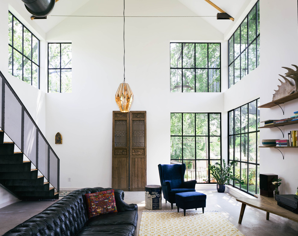 Living room - industrial living room idea in Austin with white walls and no fireplace