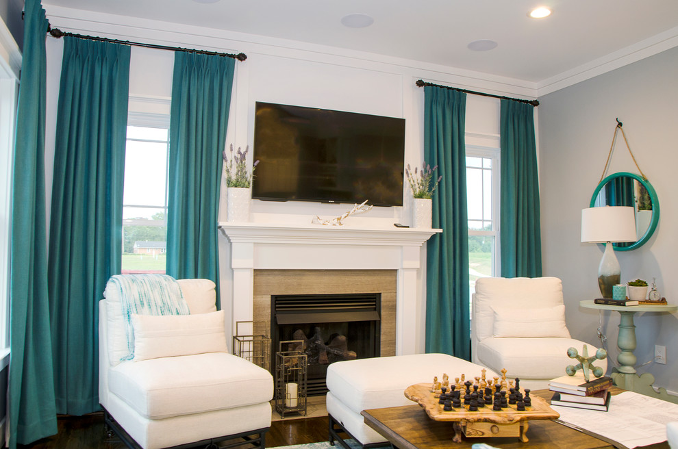 Medium sized classic grey and teal open plan living room in Richmond with blue walls, dark hardwood flooring, a standard fireplace, a stone fireplace surround, a wall mounted tv and brown floors.