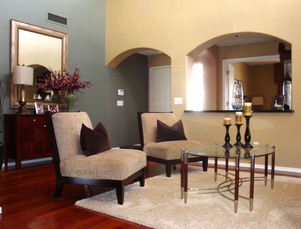 Large trendy open concept medium tone wood floor living room photo in Los Angeles with beige walls and no fireplace
