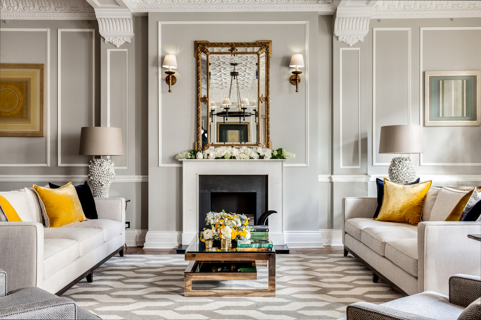 Пример оригинального дизайна: парадная гостиная комната в классическом стиле с серыми стенами, стандартным камином и ковром на полу