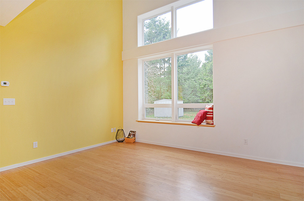 Design ideas for a large classic open plan living room in Seattle with yellow walls and bamboo flooring.