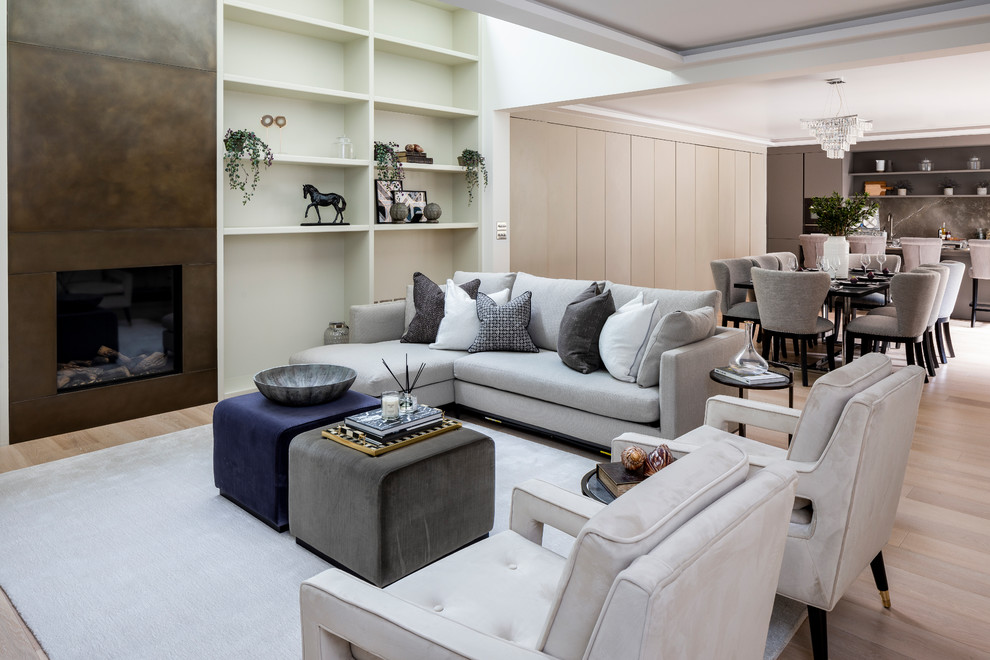 This is an example of a large classic open plan living room in London with light hardwood flooring and beige floors.