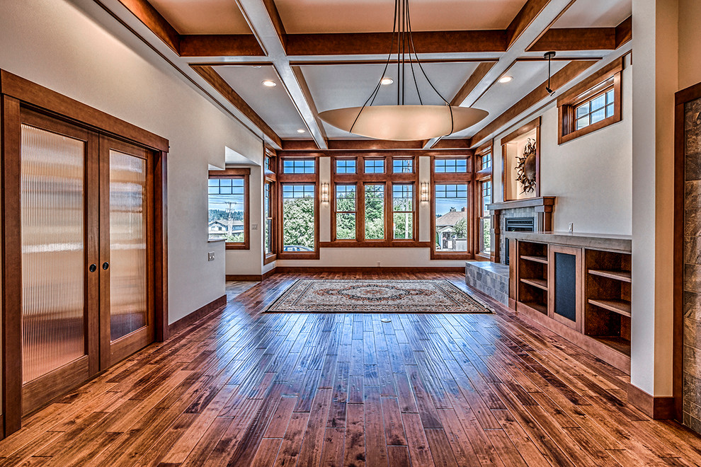 Inspiration for a large craftsman open concept medium tone wood floor living room remodel in Seattle with white walls, a standard fireplace, a tile fireplace and no tv