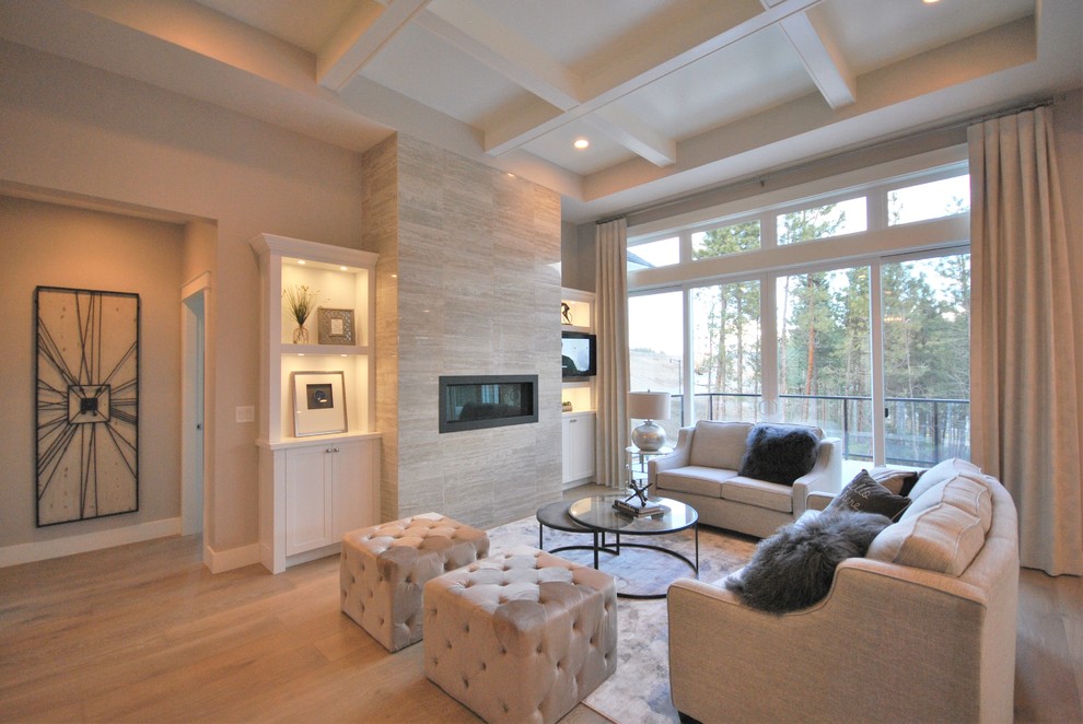 Example of a large trendy open concept light wood floor living room design in Vancouver with gray walls, a ribbon fireplace, a tile fireplace and a media wall