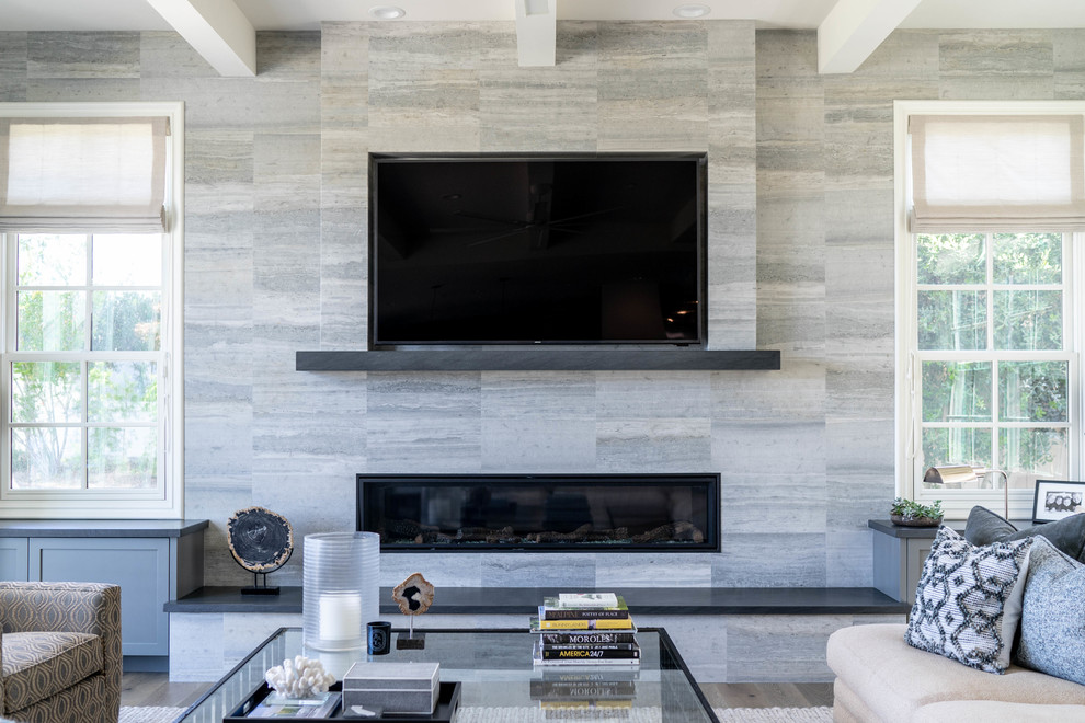 Mittelgroßes, Offenes Modernes Wohnzimmer mit grauer Wandfarbe, braunem Holzboden, Gaskamin, gefliester Kaminumrandung, TV-Wand und braunem Boden in San Diego