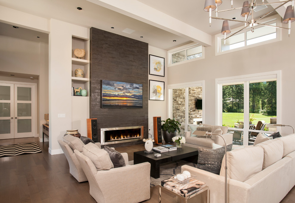 This is an example of a medium sized contemporary formal open plan living room in Seattle with grey walls, medium hardwood flooring, a standard fireplace, a metal fireplace surround, a wall mounted tv and grey floors.